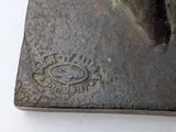 a close up of a metal object on a white surface