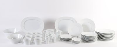 beaucoup d'assiettes et de tasses blanches sur la table