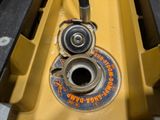 a close up of a yellow machine with a wren on it