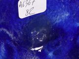 a blue vase that has a label on it