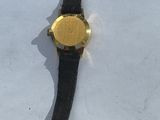 a watch that is laying on a white surface