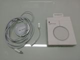 a white box with a cable attached to it next to a charger and a charger