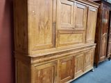 a large wooden cabinet in the middle of a room
