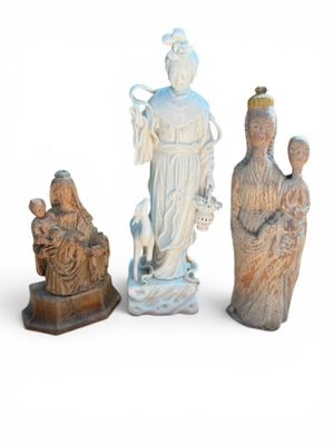three figurines of a woman, a man and a child