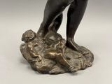 an image of a bronze statue of a man holding a dog