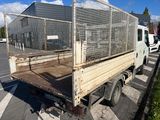 a truck that has a cage on the back of it