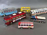 five different types of toy buses on a table
