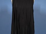 an image of a black top on a mannequin stand against a blue background