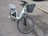 a white bicycle with a basket on the back of it
