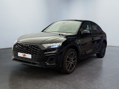 a black audi qx parked in a large room