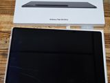 the box is open on a wooden table with a laptop in it
