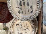 a box full of plates and bowls with a person holding one