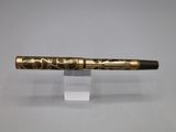 an image of a fountain pen with gold paint on it