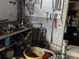Plusieurs seaux remplis d'outils sont posés sur une table dans un garage.