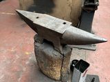 an anvil sitting on top of a piece of metal
