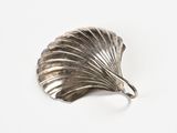 silver plated shell shaped brooch on a white background