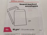 an office depot board - backed envelopes are on a white table