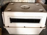a white stove sitting in a room next to a brick wall