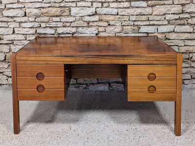 an image of a desk with drawers and a brick wall