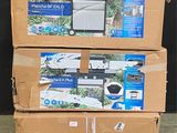 three boxes of electronic equipment are stacked on pallets in a warehouse