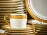 many plates and cups stacked on top of each other