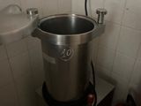a pot that is sitting on a stand in a bathroom
