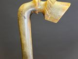 an old wooden walking stick with a wooden handle on a black background