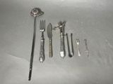 a lot of silverware on a table with a spoon and knife