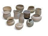many different types of vases and bowls on the table
