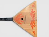 a small wooden instrument with an orange design on it