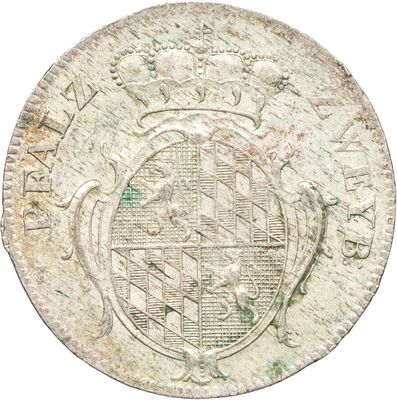 un gros plan d'une vieille pièce de monnaie sur laquelle figure une croix