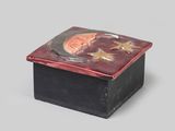 an image of a small black box with a red and gold design