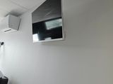 a flat screen tv mounted on the wall in a room