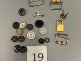 many different types of buttons and clasps on a table