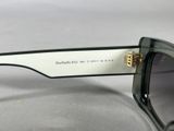 the sunglasses are black and white with a gold clasp