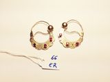two pairs of gold earrings with garnets on a white background