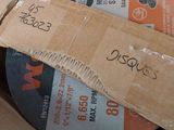 a cardboard box that has a couple of discs inside of it
