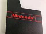 a close up of a nintendo logo on top of a black box