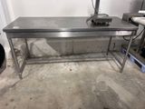a stainless steel work table in a garage