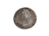 a close up of a coin on a white surface