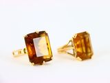 une paire de boucles d'oreilles en or jaune et citrine sur fond blanc