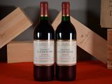two bottles of wine sitting next to each other on a table
