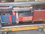 many books stacked on top of each other on a cart