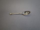 a silver spoon with a spoon handle on a table
