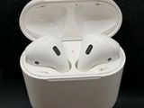 a pair of white airpods sitting in a white box