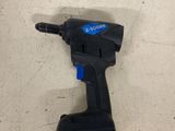 a close up of a cordless drill on a white surface