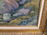 an oil painting of a mountain scene with rocks in a gold frame
