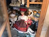 a small cabinet with a lot of dolls in it