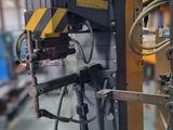 an image of a machine that is working on a piece of metal