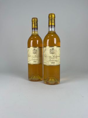 two bottles of wine sitting next to each other on a table